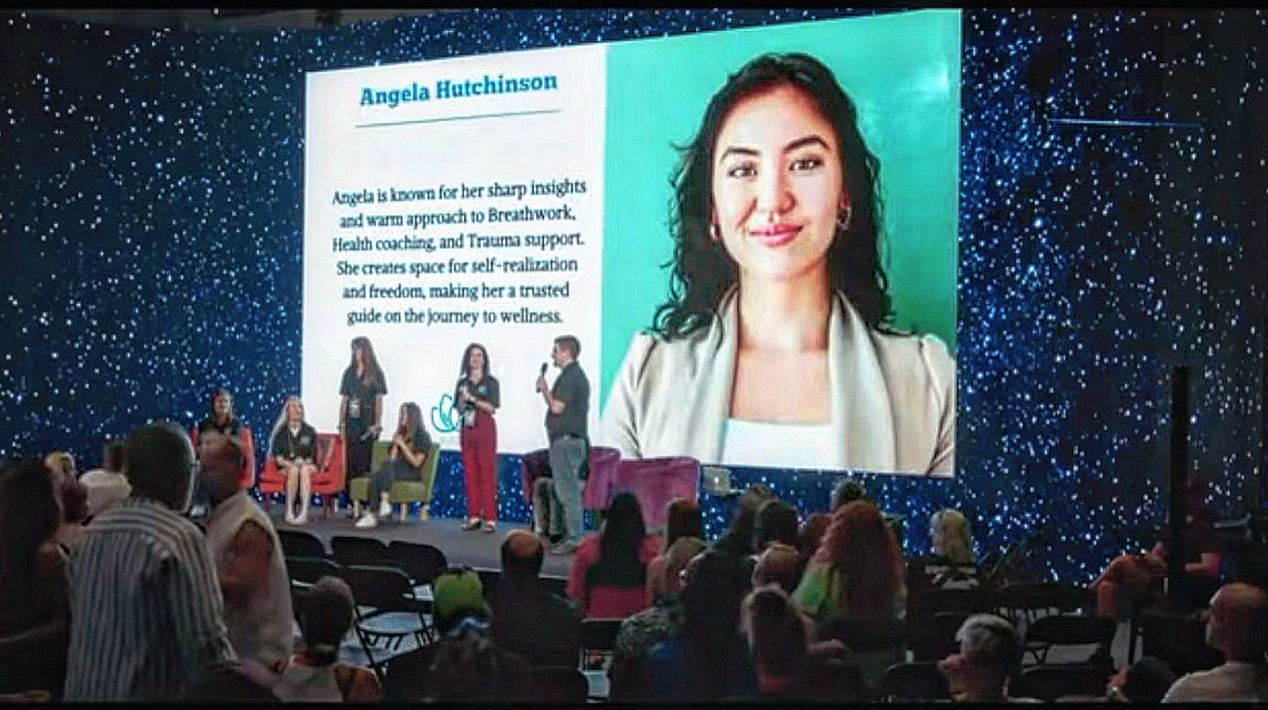 Angela Hutchinson featured on the main stage screen at MindValley